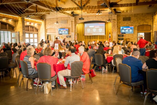 Guests seated at round tables during the Quarterback S.A.C.K. Kick-Off Lunch