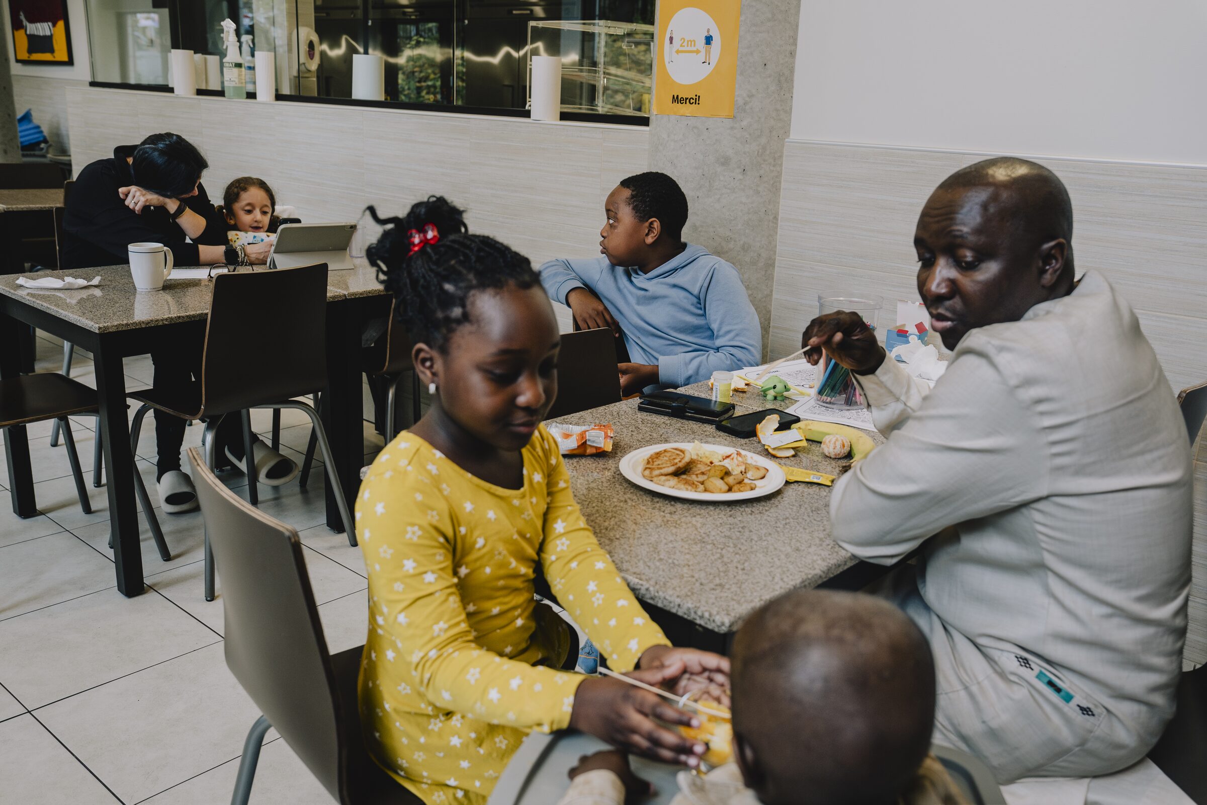 Families sharing dinner at a long table